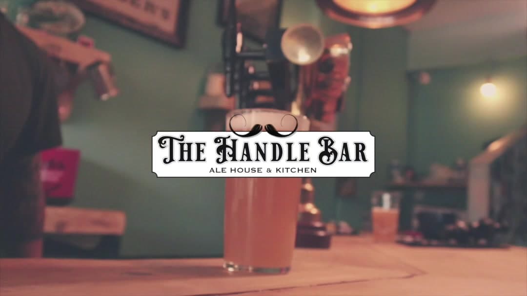 Pint on the bar with The Handle Bar logo overlay