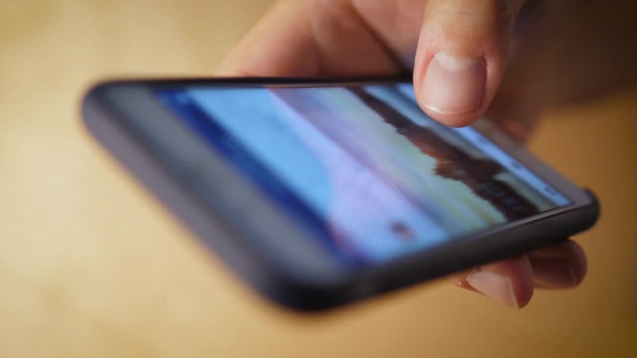 Hand scrolling a smartphone close up