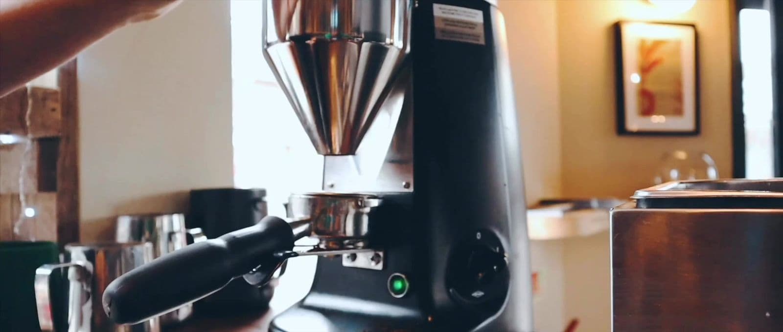 Coffee grinder close up filmed in a cafe